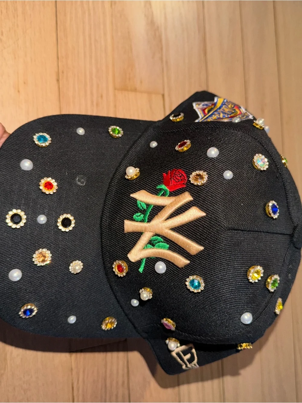 Embellished Black Baseball Cap with Gold Embroidered Rose Accent